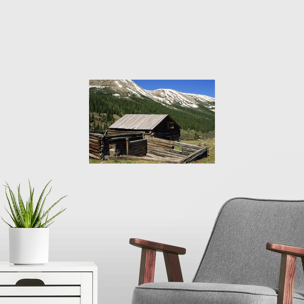 A modern room featuring Log cabin at Independence town site, with Sawatch Mountains, Colorado, USA