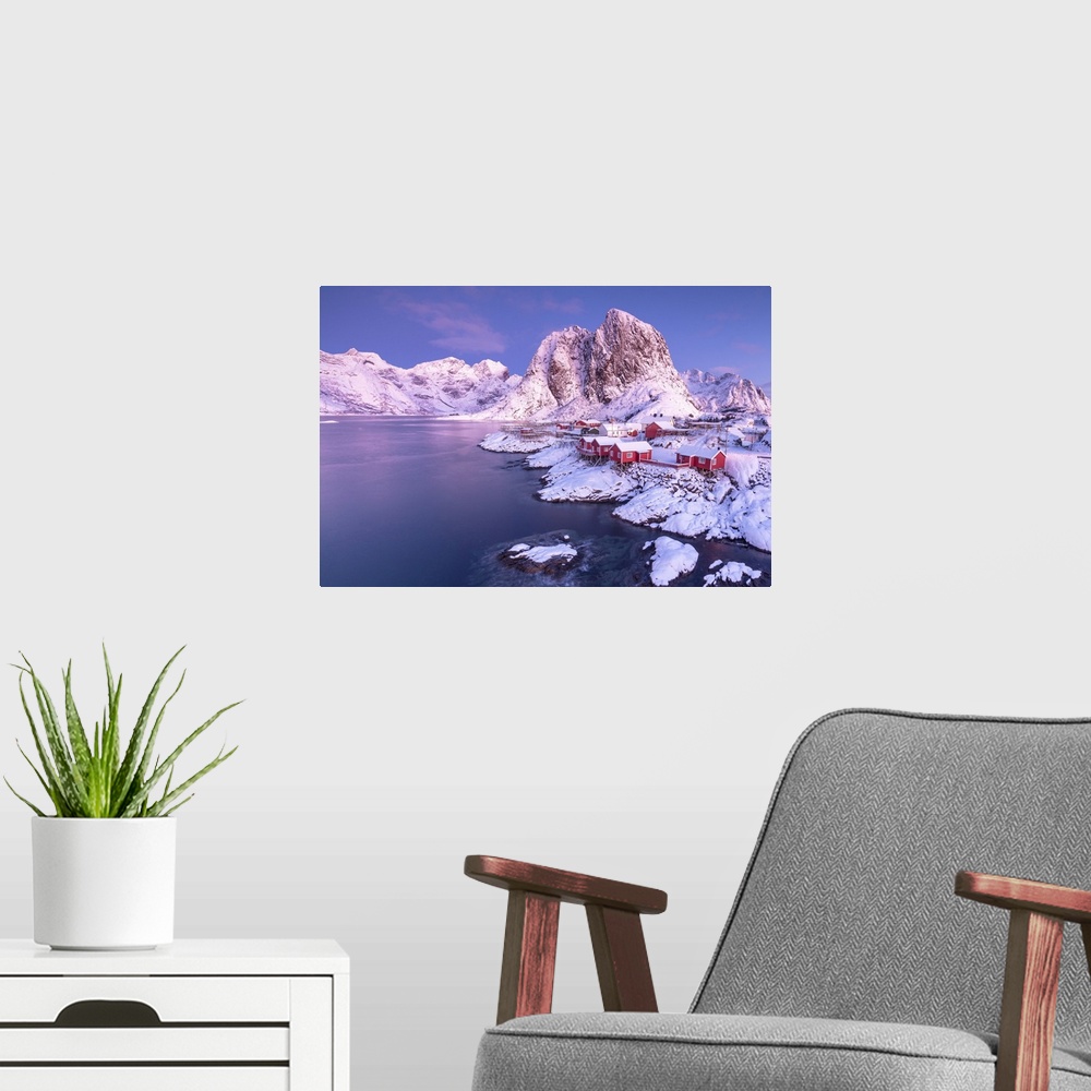 A modern room featuring Pink sunrise on snowy peaks surrounded by the frozen sea around the village of Hamnoy, Nordland, ...
