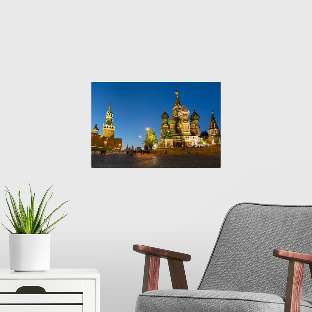 A modern room featuring Red Square, St. Basil's Cathedral and the Savior's Tower of the Kremlin lit up at night, Moscow, ...