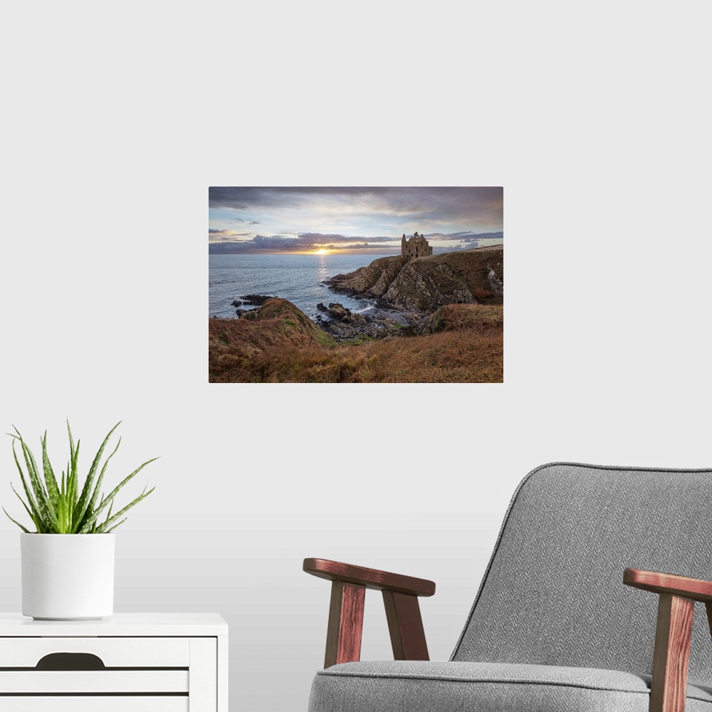A modern room featuring Ruins of Dunskey Castle on rugged coastline at sunset, Portpatrick, Dumfries and Galloway, Scotla...