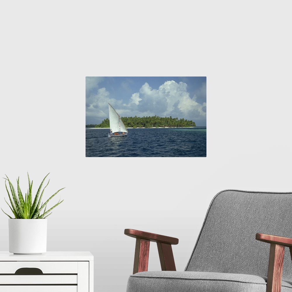 A modern room featuring Sailing boat off a tropical island in the Maldive Islands, Indian Ocean, Asia