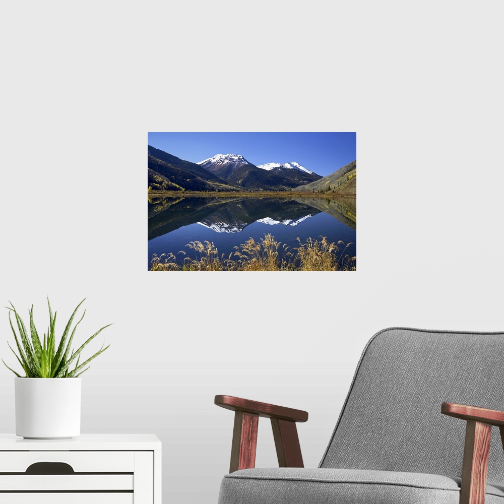 A modern room featuring Snow-capped Red Mountain reflected in Crystal Lake with fall colors, Colorado