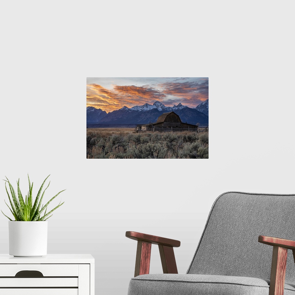 A modern room featuring Sun setting over the Teton Range at Moulton Barn, Grand Teton National Park, Wyoming, United Stat...