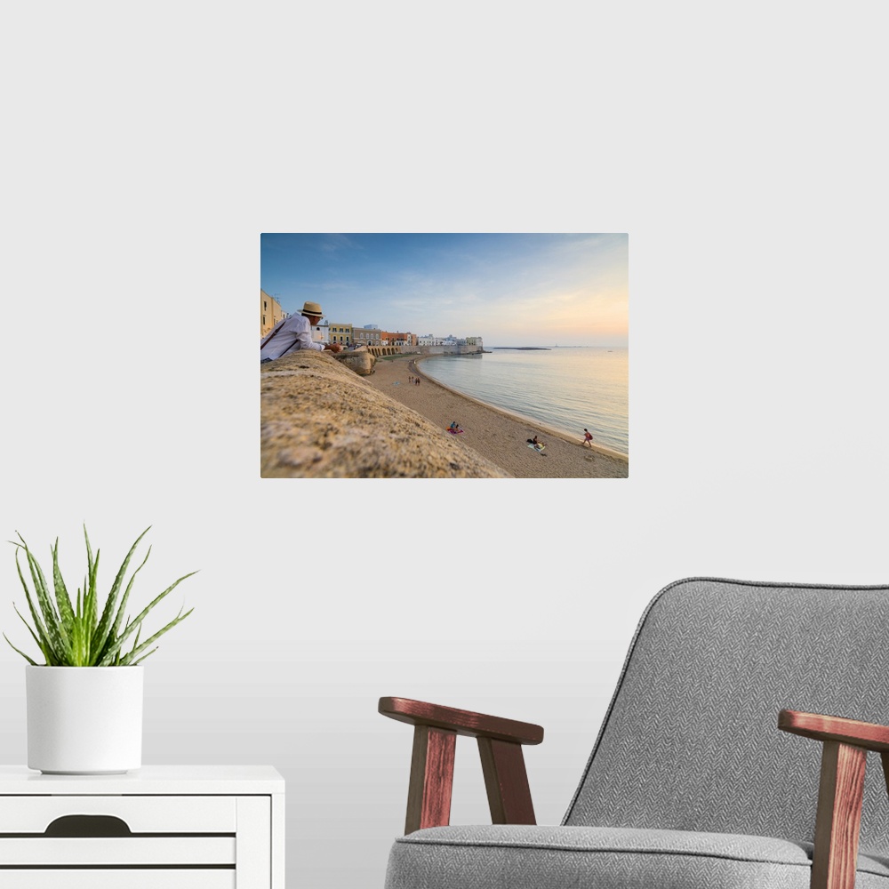 A modern room featuring Sunset frames the beach and the turquoise sea, Gallipoli, Province of Lecce, Apulia, Italy