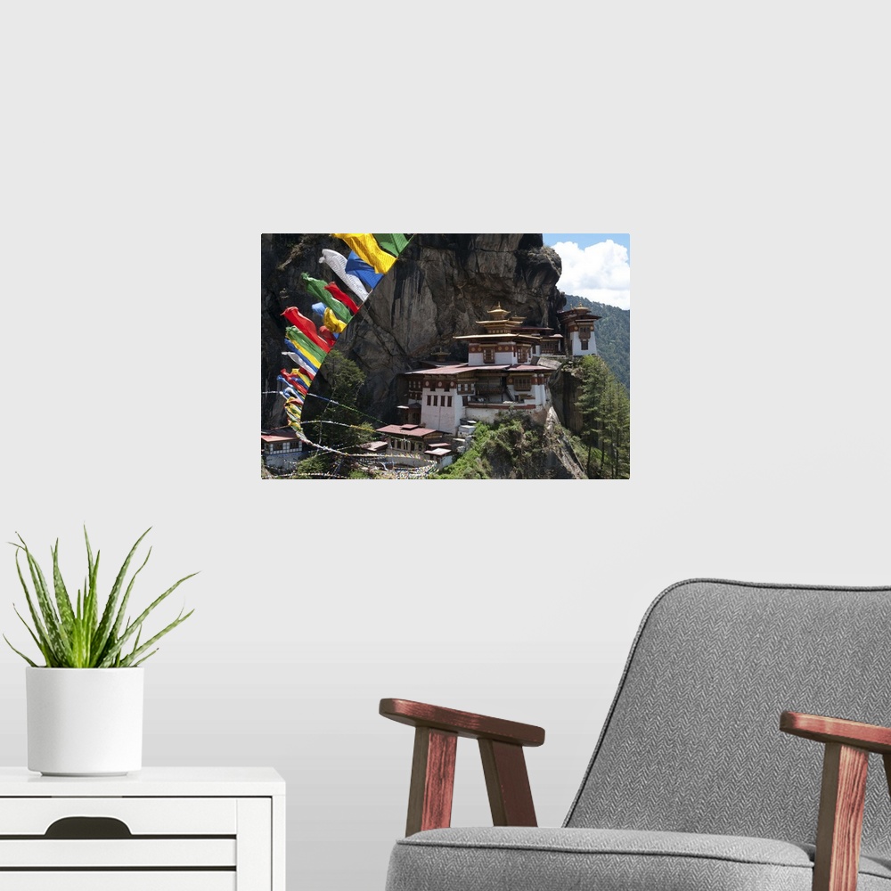 A modern room featuring Taktshang Goemba with prayer flags and cliff, Paro Valley, Bhutan
