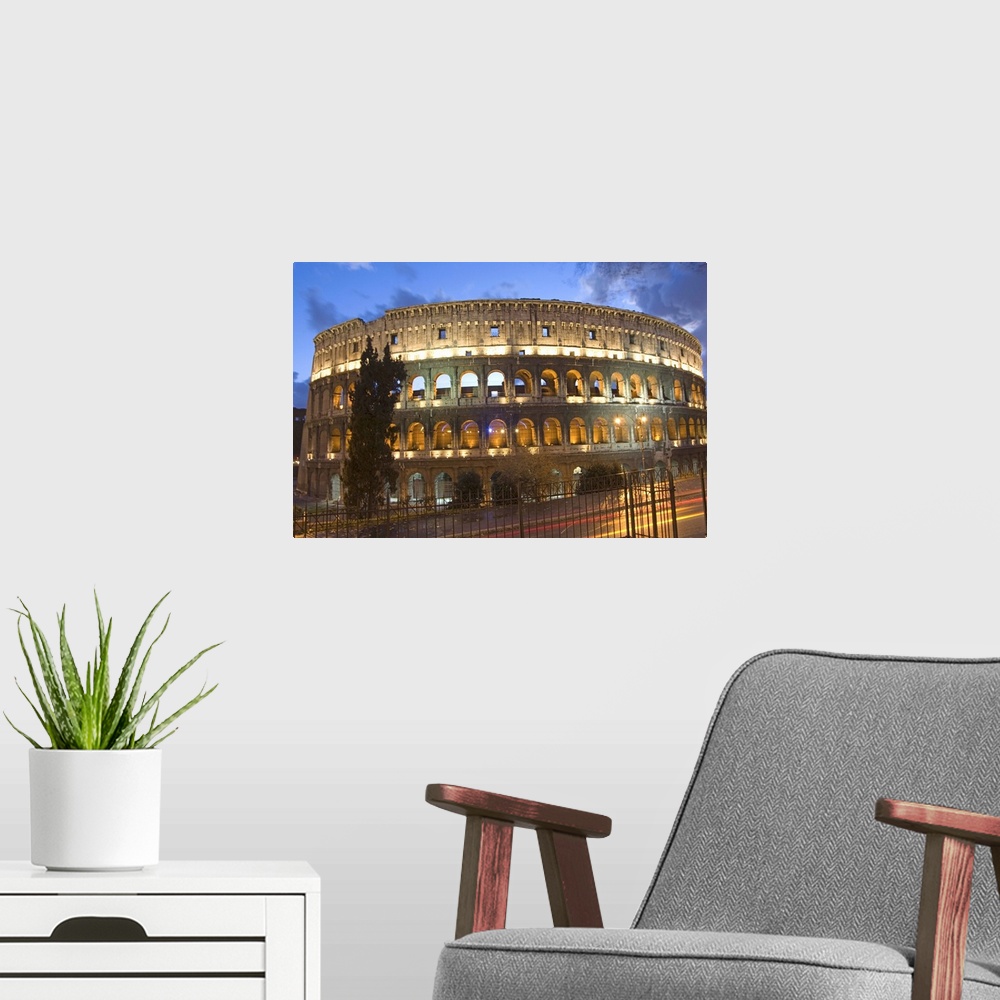 A modern room featuring The Colosseum at night with traffic trails, Rome, Lazio, Italy