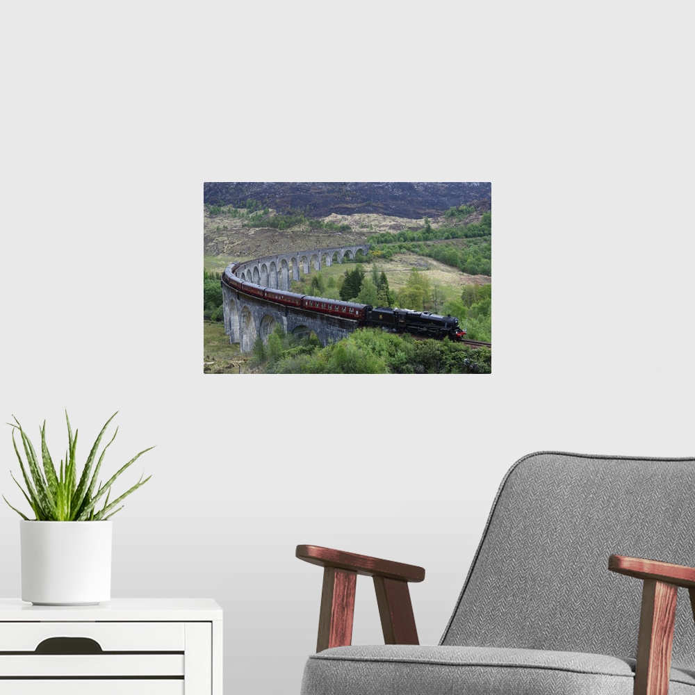 A modern room featuring The Jacobite Express crossing Glenfinnan Viaduct, Mallaig, Highlands, Scotland, United Kingdom, E...