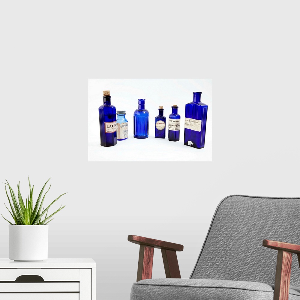 A modern room featuring Antique pharmacy bottles.