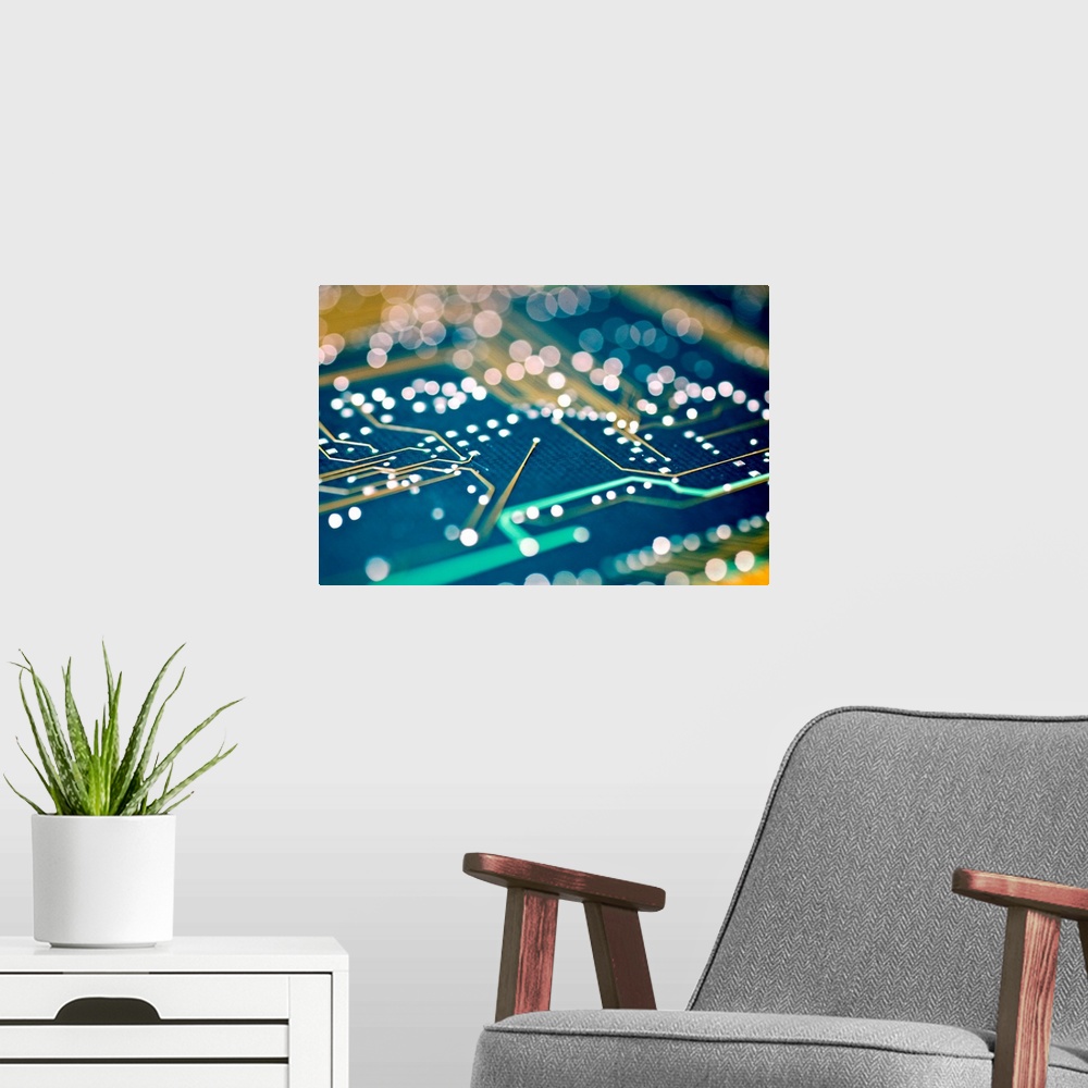 A modern room featuring Printed circuit board (PCB). Soft-focus image showing the holes (dots) in a PCB into which compon...