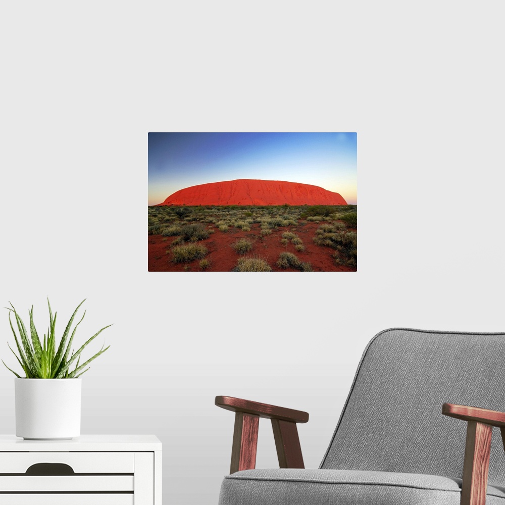 A modern room featuring Uluru (Ayers Rock) at sunrise. Uluru is a large sandstone rock formation in the southern part of ...