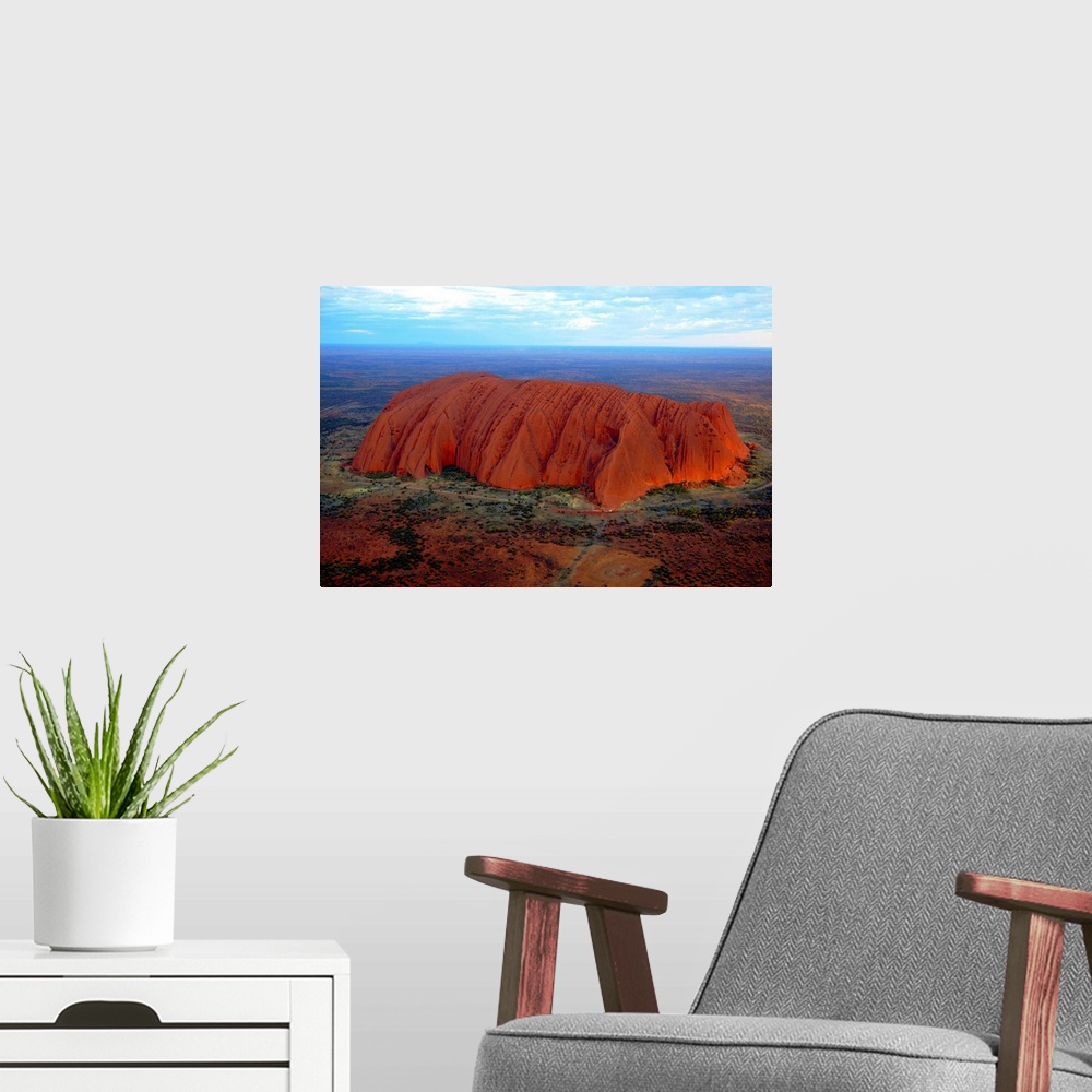 A modern room featuring Uluru (Ayers Rock) at sunset. Uluru is a large sandstone rock formation in the southern part of t...
