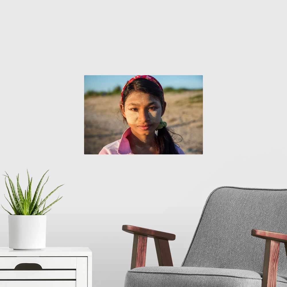 A modern room featuring Burmese girl with facepaint at sunrise, Mandalay, Burma.