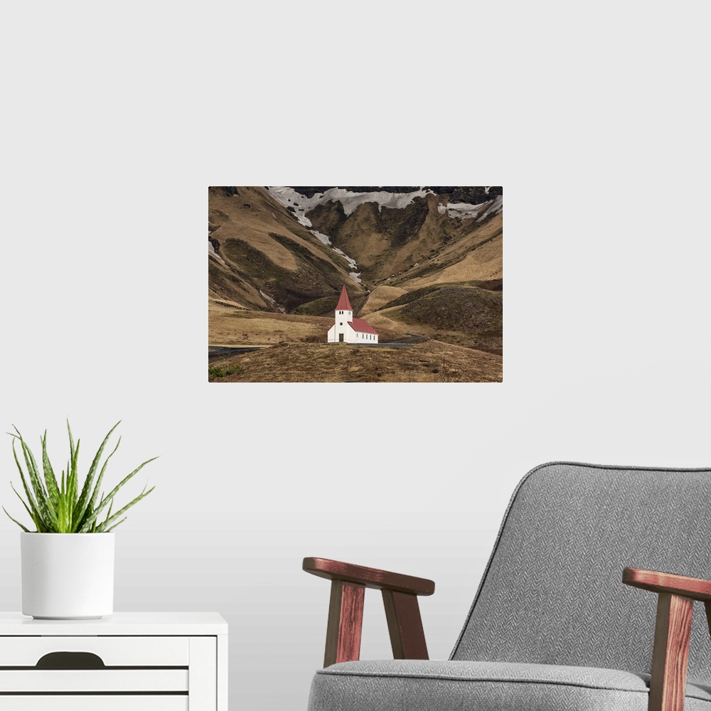 A modern room featuring The beautiful church on the hillside in Vik, Iceland.