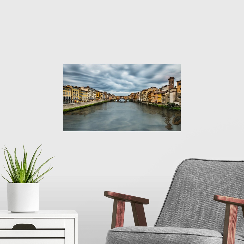 A modern room featuring The Pontevecchio Bridge in Florence at sunset.