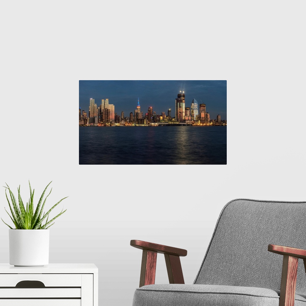 A modern room featuring New York City skyline at sunset