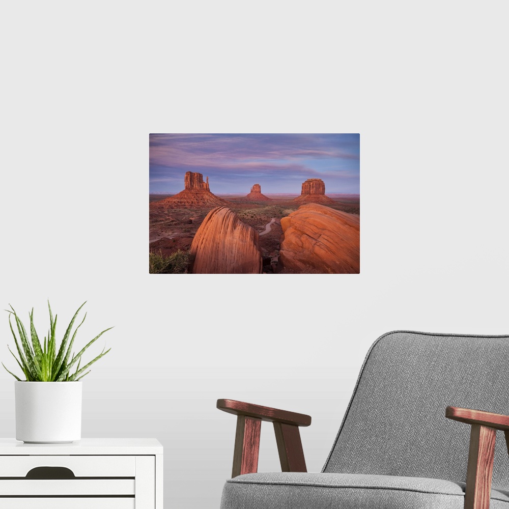 A modern room featuring The Mittens in Monument valley, Arizona at sunset