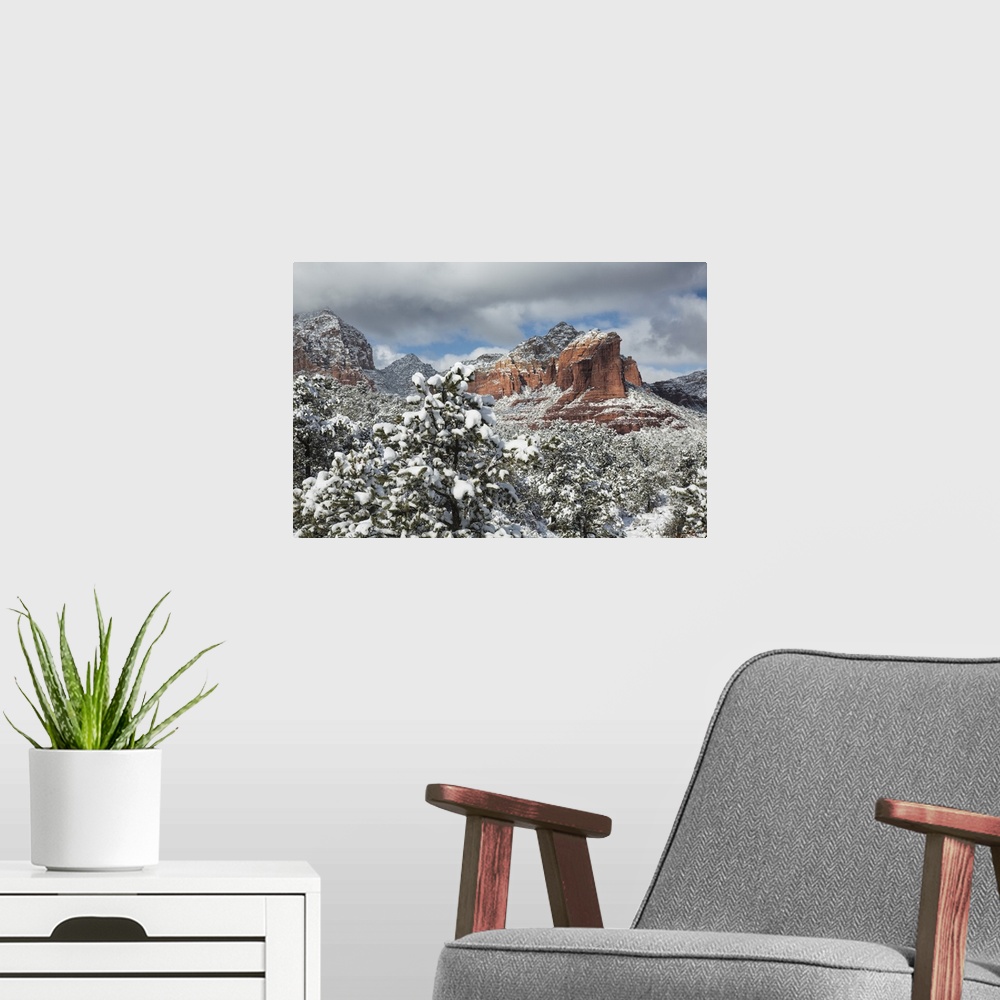 A modern room featuring The red rocks of Sedona, Arizona covered in snow.