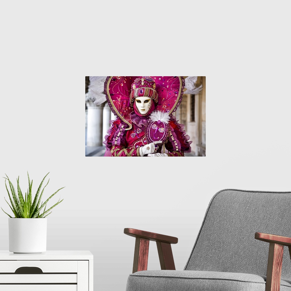 A modern room featuring Woman in masquerade outfit at Carnival in Venice, Italy.