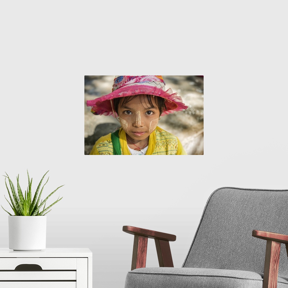 A modern room featuring Young Burmese girl with Tanaka face paint
