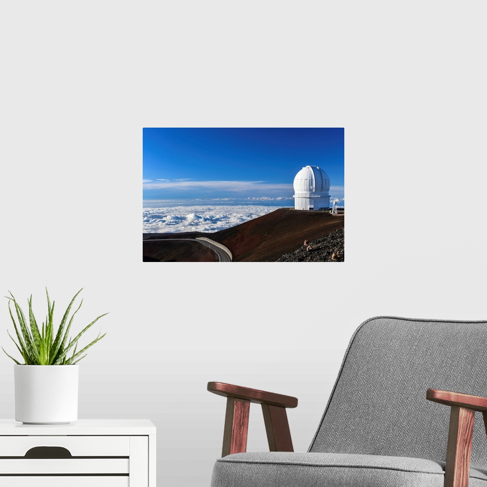 A modern room featuring Big Island Hawaii. The late afternoon sun illuminates an observatory atop Hawaii's Mauna Kea at s...
