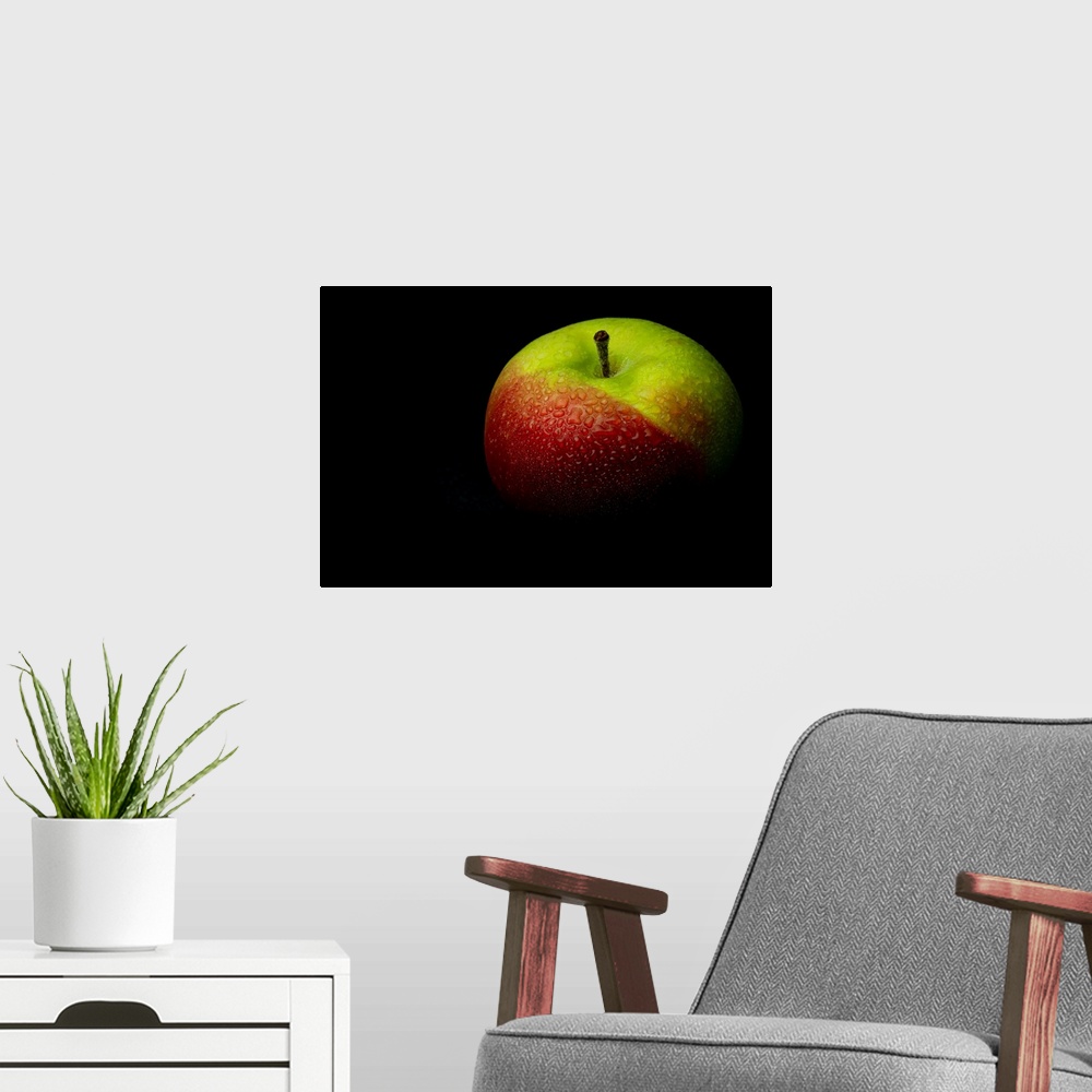A modern room featuring A close up photograph of a fresh Macintosh apple with waterdrops.