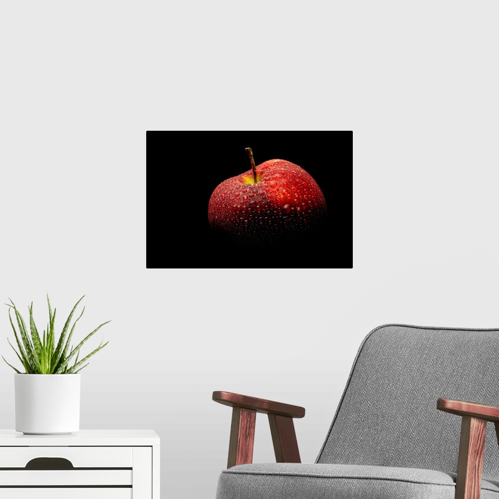 A modern room featuring A close up photograph of a fresh Red Delicious apple with waterdrops.