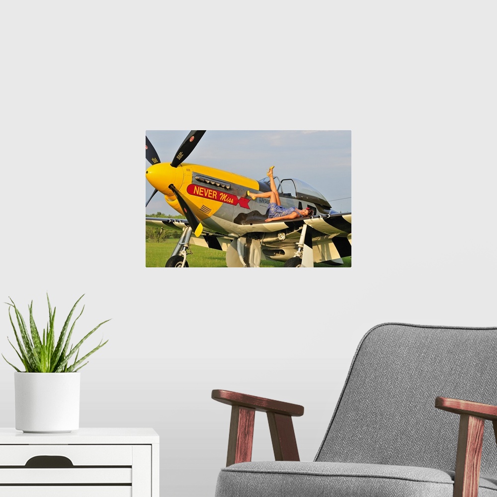 A modern room featuring 1940's style pin-up girl lying on the wing of a P-51 Mustang fighter plane.