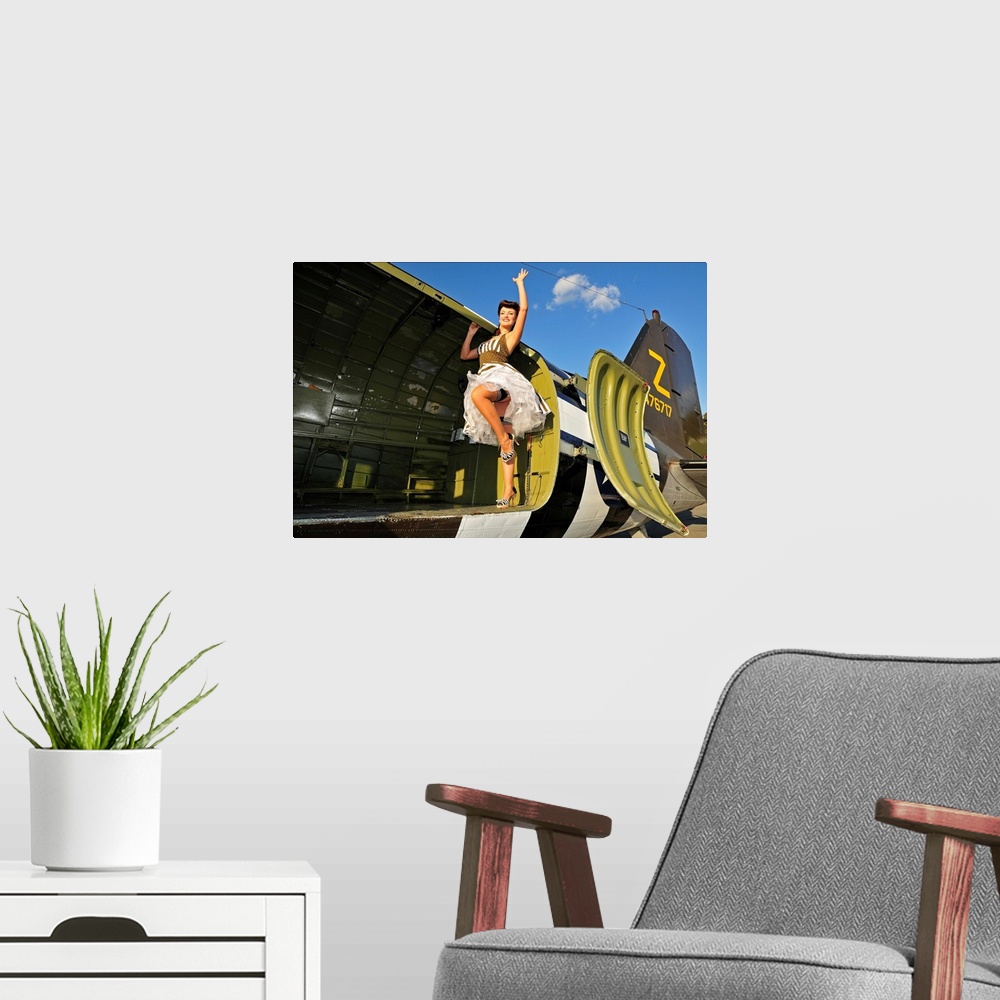 A modern room featuring Sexy 1940's style pin-up girl standing inside of a World War II C-47 Skytrain aircraft.