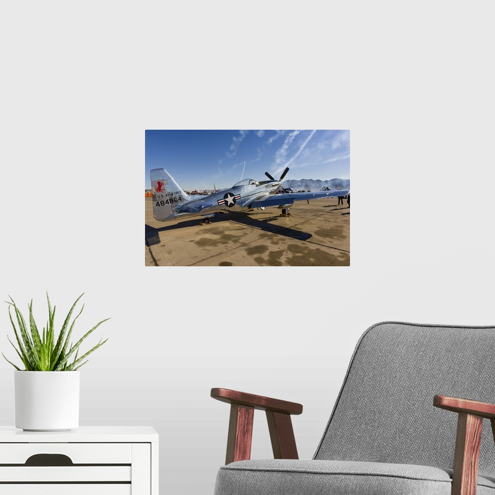 A modern room featuring A P-51 Mustang parked on the ramp at Nellis Air Force Base, Nevada.