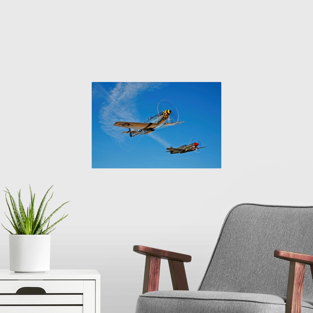A modern room featuring A North American P-51D Mustang Kimberly Kaye and a Curtiss P-40E Warhawk in flight near Chino, Ca...