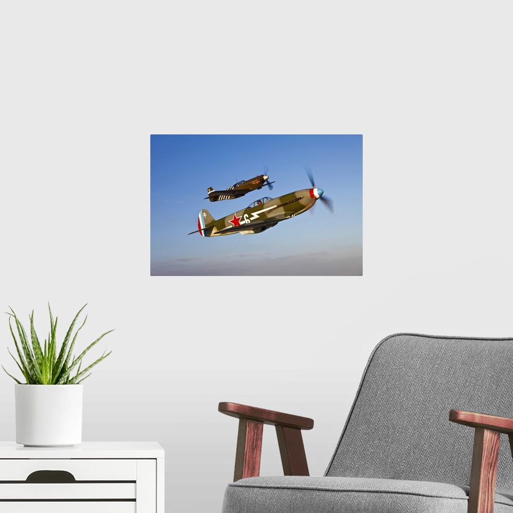 A modern room featuring A Yakovlev Yak-9 fighter plane and a North American P-51A Mustang in flight near Chino, California.