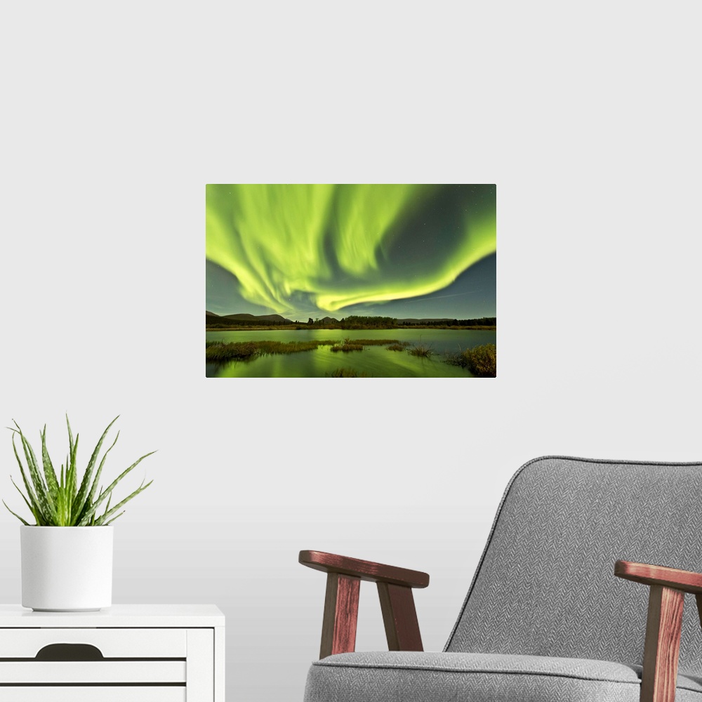 A modern room featuring Aurora borealis over Fish Lake, Yukon, Canada.