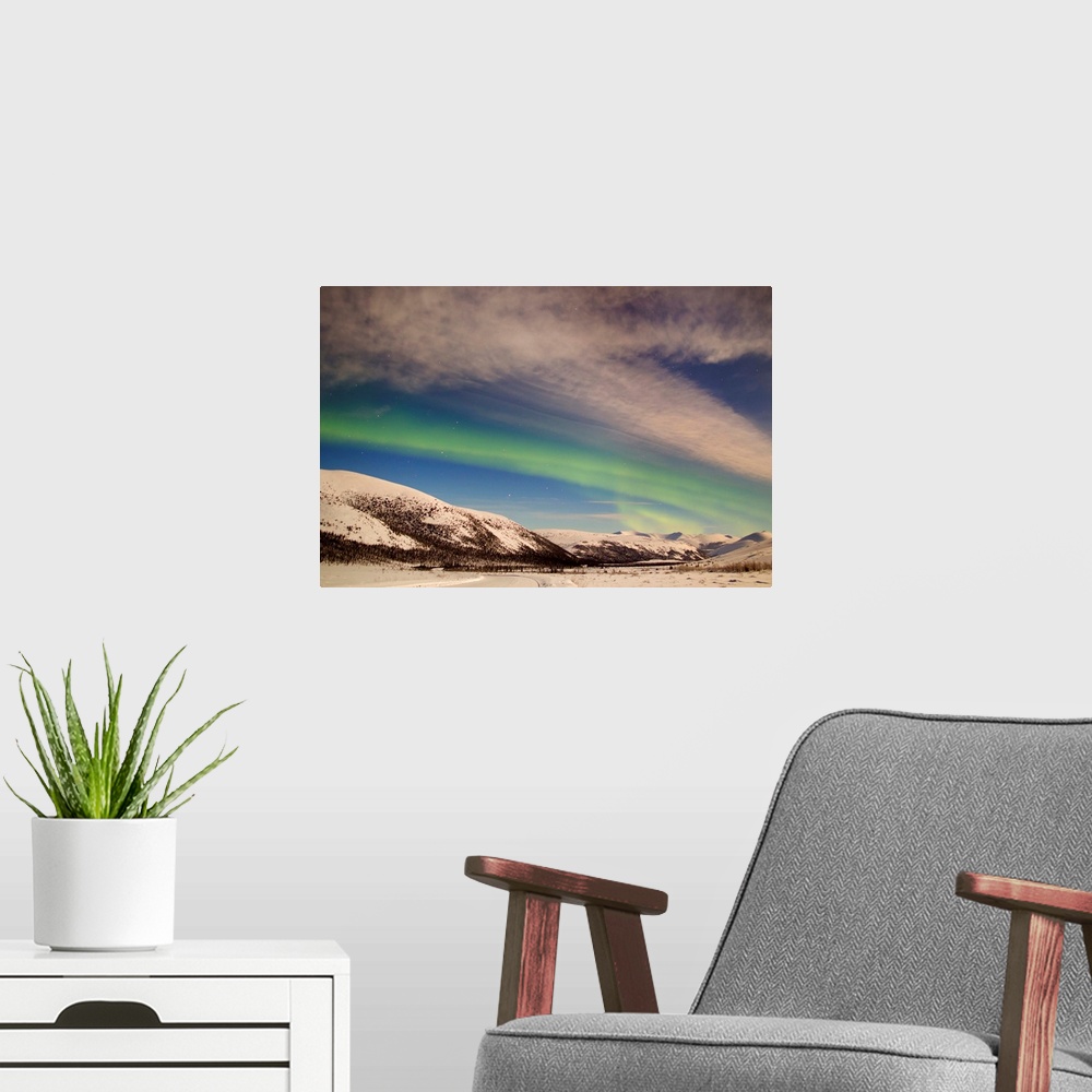 A modern room featuring Aurora borealis with moonlight over Ogilvie Mountains, Dempster Highway, Yukon, Canada.