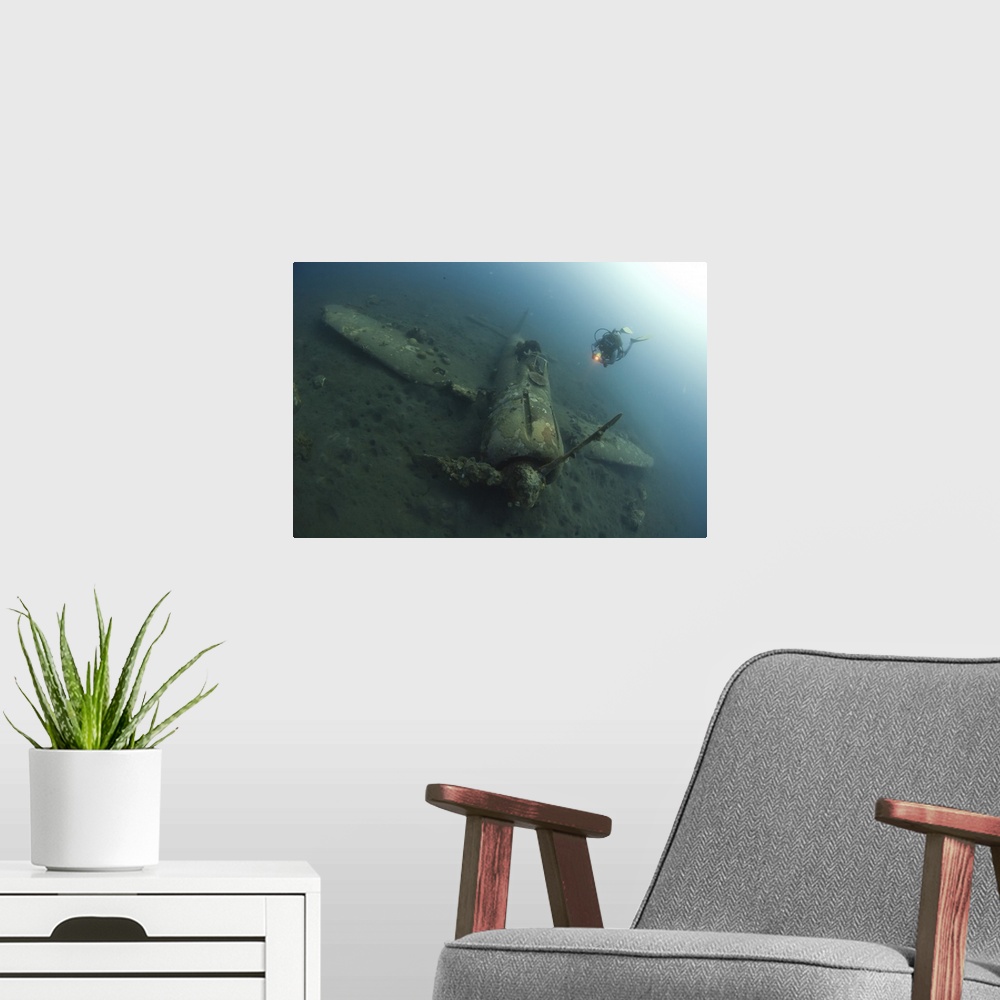 A modern room featuring Diver explores the wreck of a Mitsubishi Zero fighter plane.