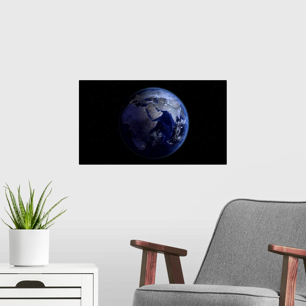 A modern room featuring Planet Earth showing Africa, Europe and Asia, half night and half day with city lights