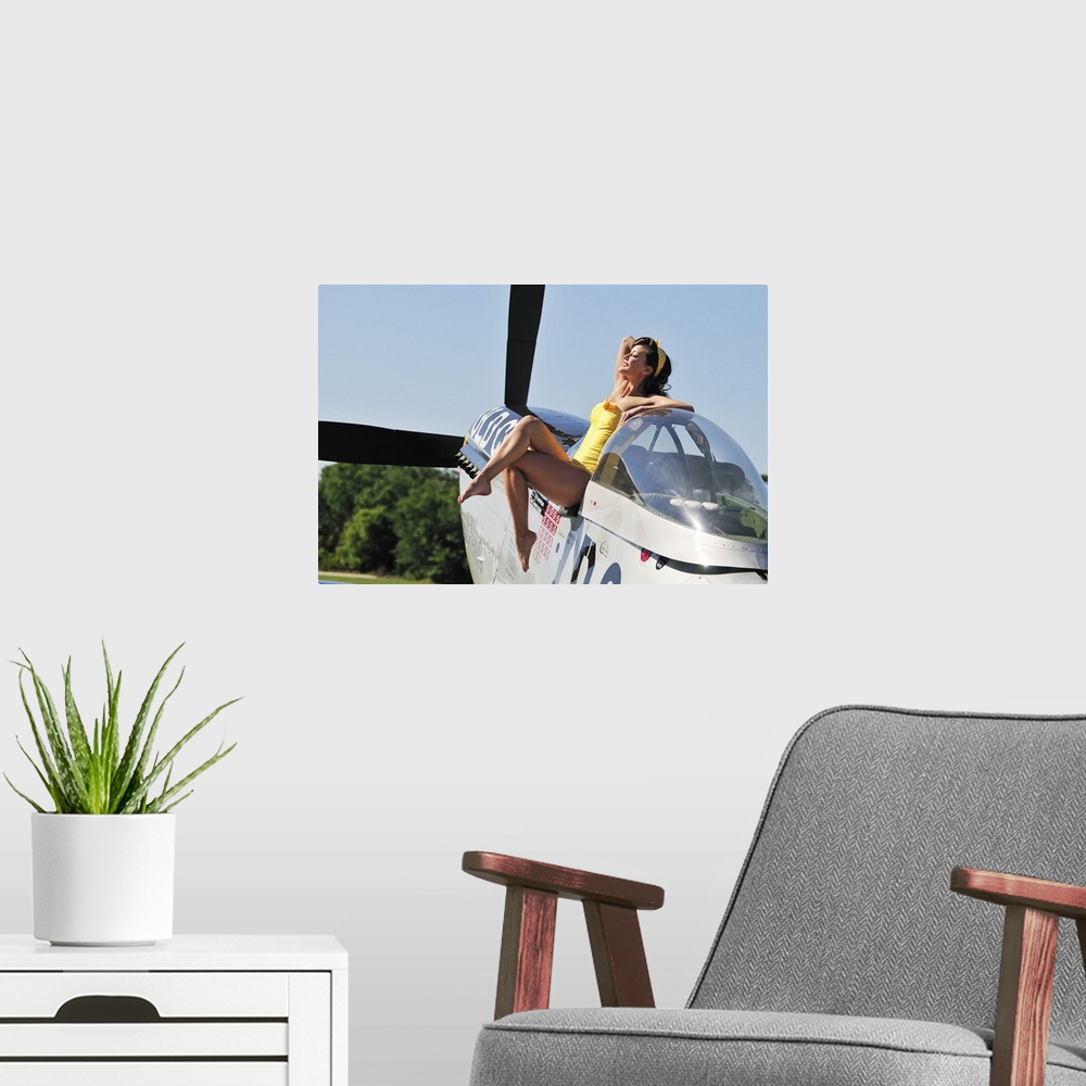 A modern room featuring Retro pin-up girl sitting outside the cockpit of a World War II era P-51 Mustang.