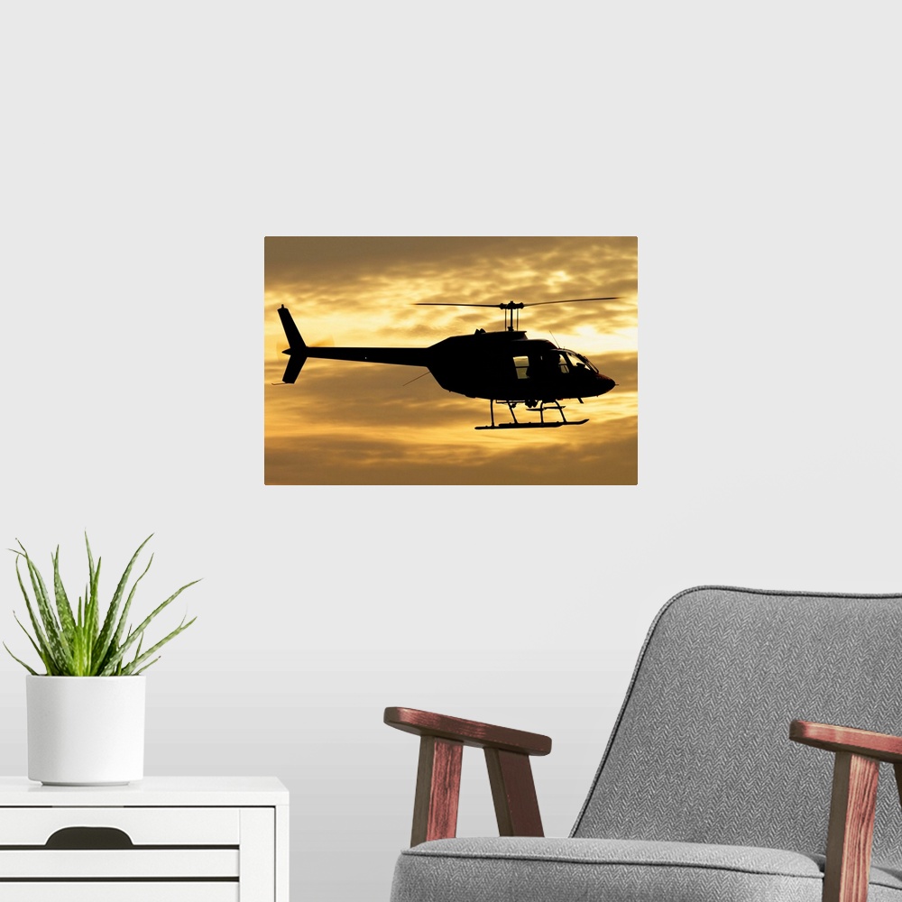 A modern room featuring Silhouette of a Bell 206 utility helicopter of Italy's Vigili del Fuoco flying over Italy.