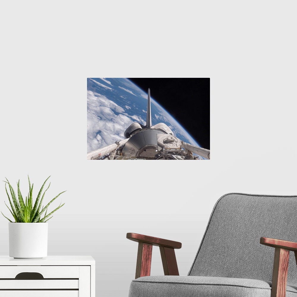 A modern room featuring Space Shuttle Discovery backdropped by Earth