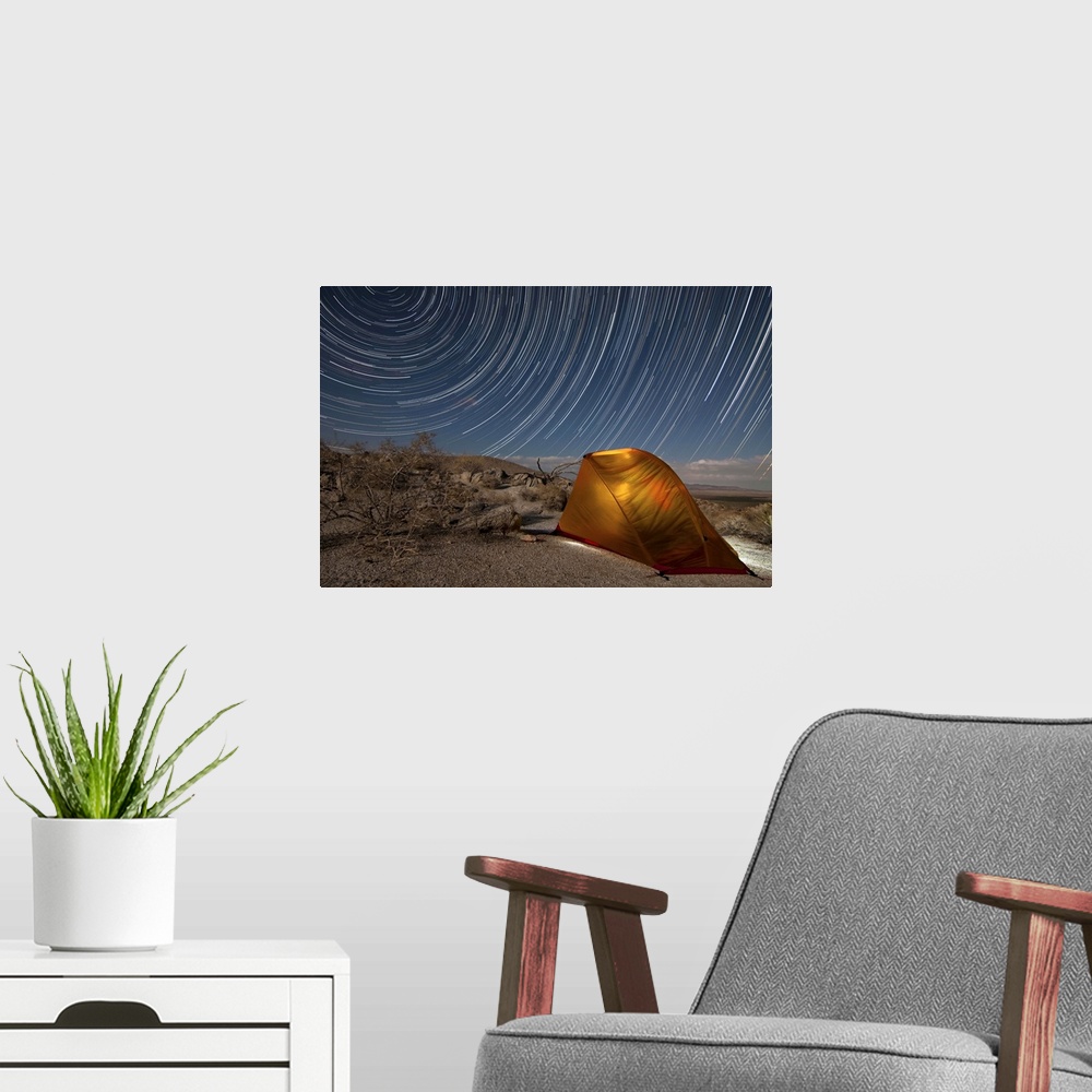 A modern room featuring Star trails above a campsite in Anza Borrego Desert State Park, California.