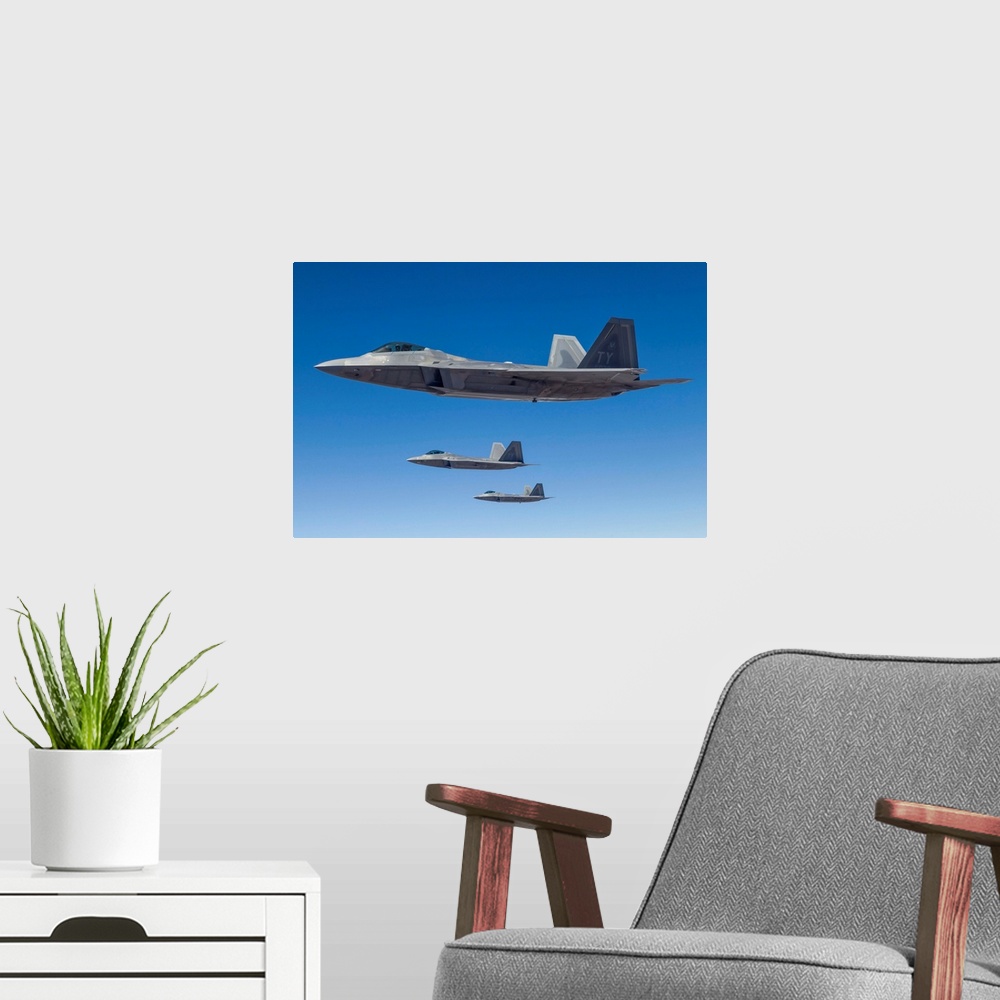 A modern room featuring Three U.S. Air Force F-22 Raptors cruise above Nevada.