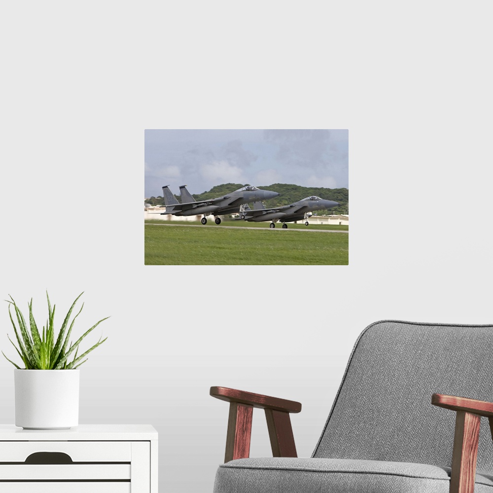 A modern room featuring Two F-15's from the 18th Wing take off in formation at Kadena Air Base, Okinawa, Japan.