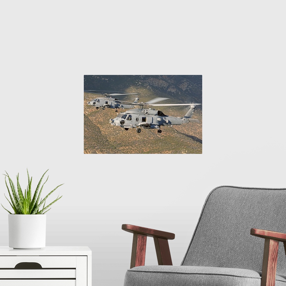A modern room featuring Two MH-60 helicopters of the U.S. Navy Blue Hawks squadron flying over Fallon, Nevada.