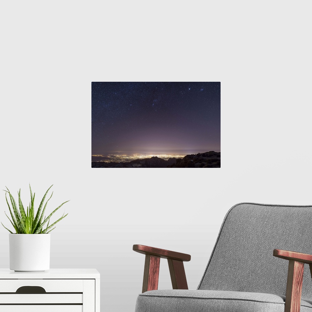 A modern room featuring A view from midway up Mount Lemmon, looking down into Tucson, Arizona. Orion, Jupiter, and the Pl...