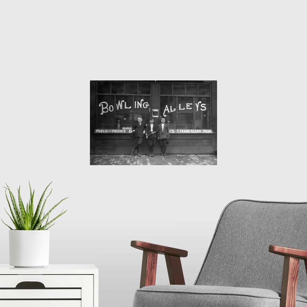 A modern room featuring Vintage photo of a row of young boys posing in front of the Les Miserables bowling alley in Lowel...