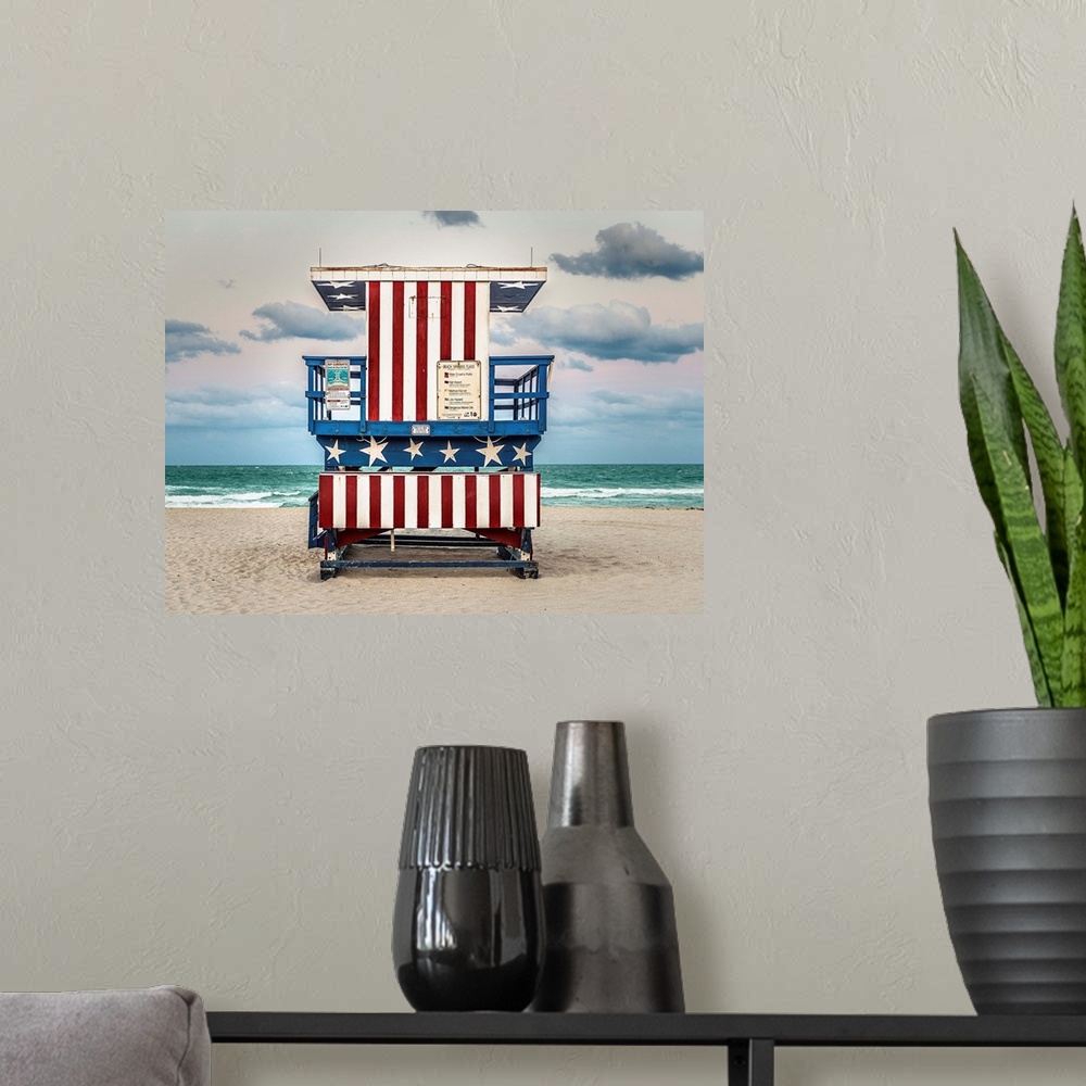 A modern room featuring Photograph of a lifeguard tower with an American flag design on the beach.