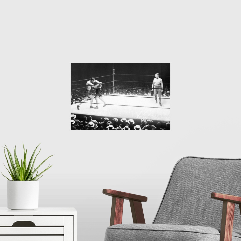 A modern room featuring American boxer. Jack Dempsey and Jack Sharkey in the second round of their heavyweight boxing mat...