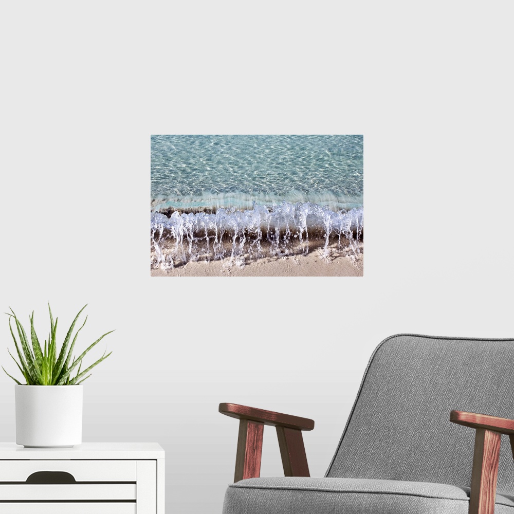 A modern room featuring Photograph of a small wave hitting the shore of a beach.