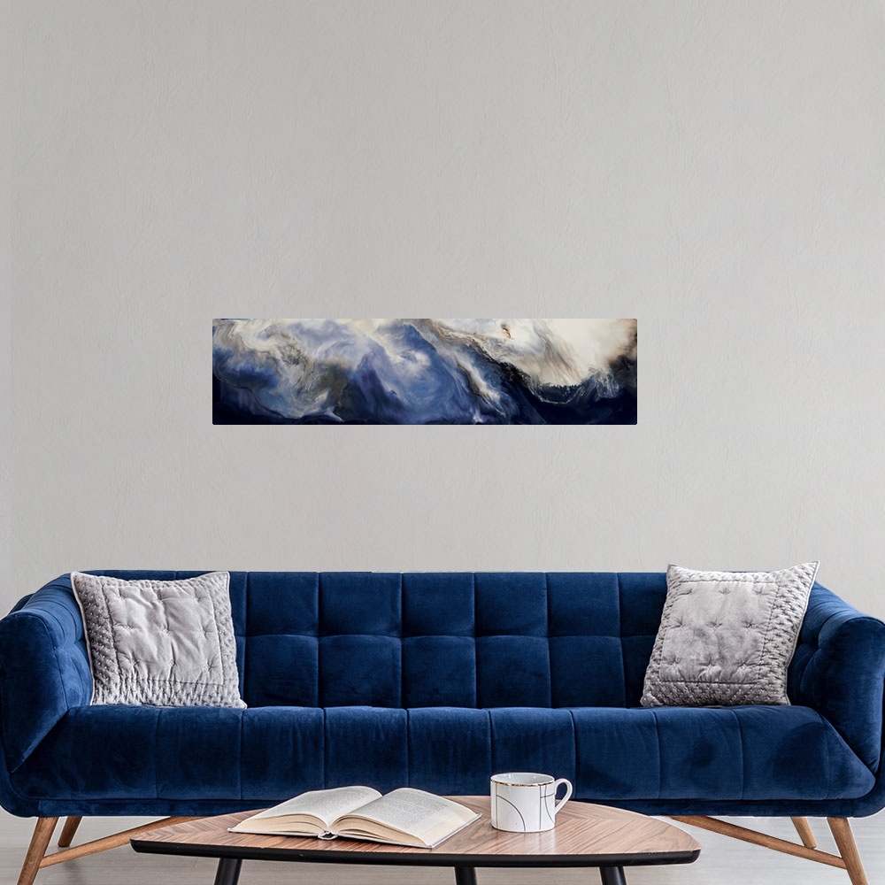 A modern room featuring Panoramic abstract painting with deep blue hues forming together with brown and white hues to cre...