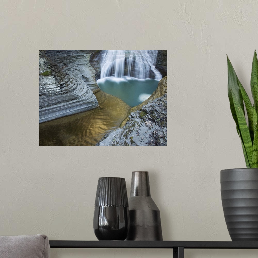 A modern room featuring Waterfall and a turquoise pool among striated rock formations in Ithaca, New York.