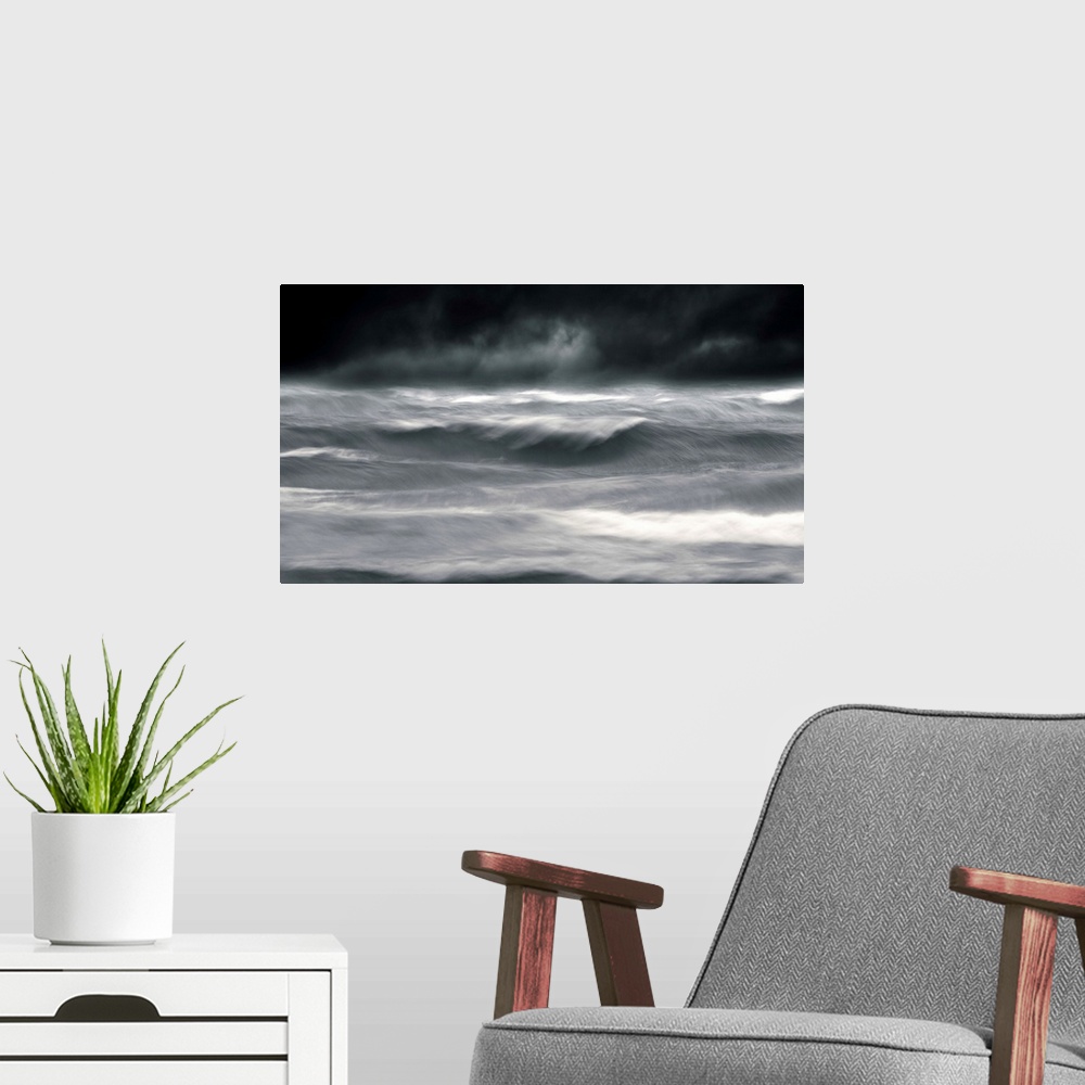 A modern room featuring Powerful waves in a seascape under a dark stormy sky